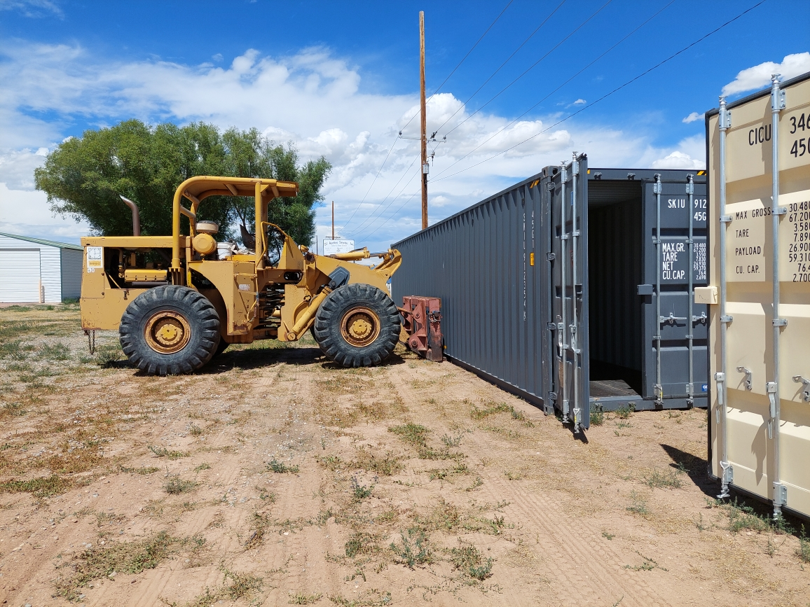 Customer loading belongings into a steel shipping container at Fort Knox Self Storage Vernal